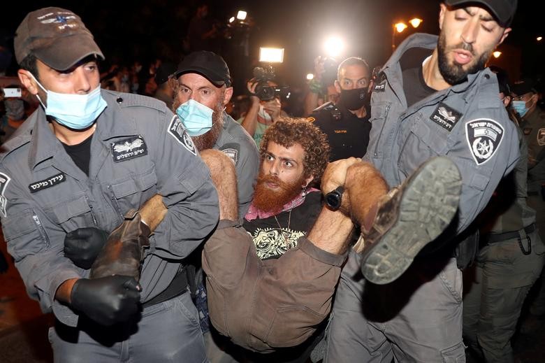Police detain a man during a protest against Prime Minister Benjamin Netanyahu and his government's handling of the coronavirus crisis, near Netanyahu's residence in Jerusalem J. REUTERS/Ammar Awad